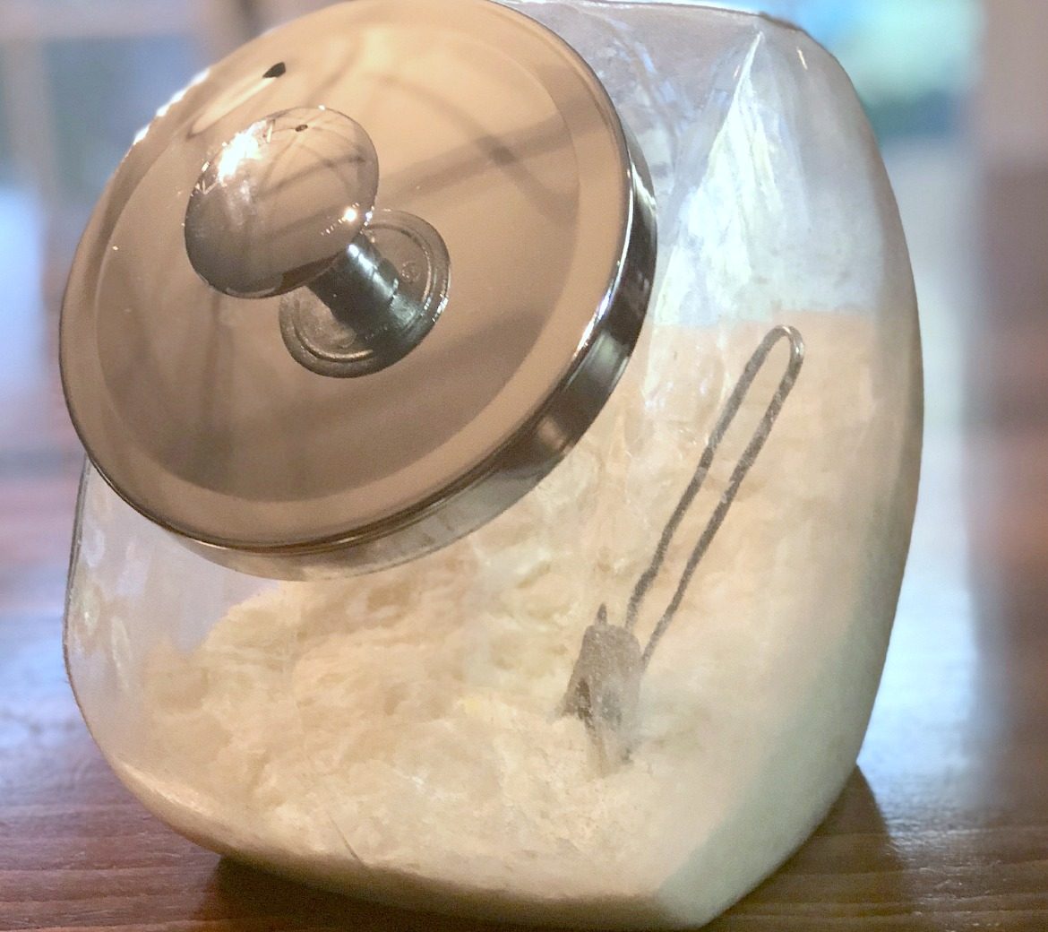 How To Make Laundry Detergent On The Skinny showing detergent in glass container