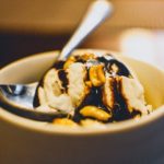 What Makes A Thing Better? Old Fashioned Hot Fudge chocolate sauce dribbled on top of vanilla ice cream in a bowl