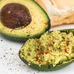 Super Bowl Sunday! Celebrating The Healthy Way upclose image of spread served in avocado shell sprinkled with paprika
