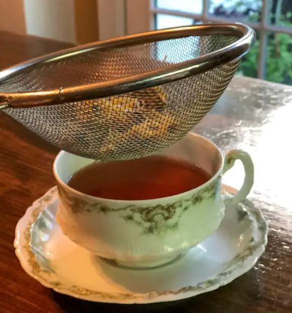 19 Uses For Calendula Tea straining flowers