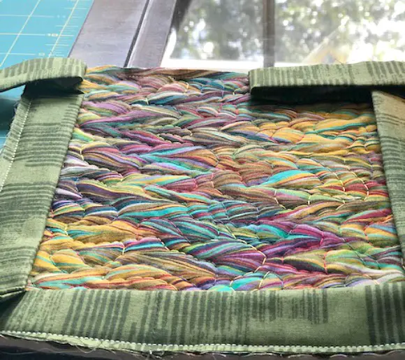 Simple Quilted Potholder Tutorial image with binding opening ready to stitch together
