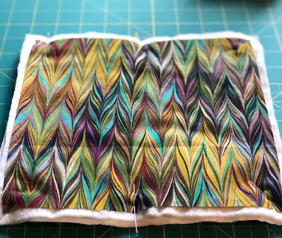 Simple Quilted Potholder Tutorial layers of front and back fabric with batting and insul-brite sandwiched together and pinned ready for quilting