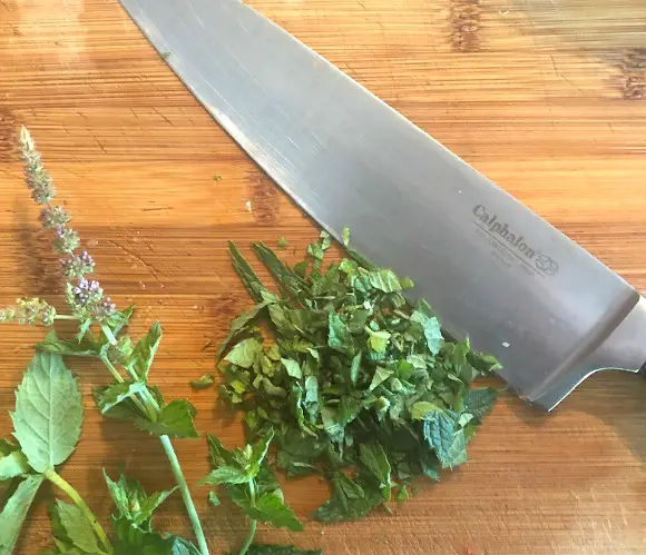 Best Pineapple Salsa Recipe fresh herbs chopped on cutting board