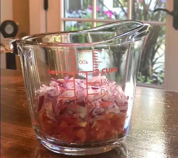 Best Pineapple Salsa Recipe onion and red pepper diced in measuring cup