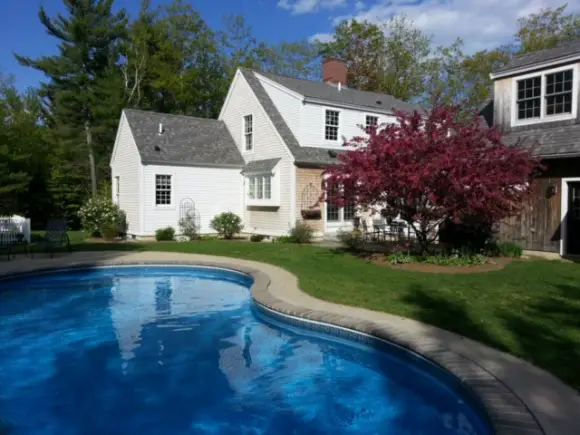 Why We Should DIY - Getting To The Root Of It backyard picture with pool and blooming crab apple tree