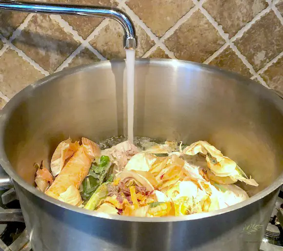 Bone Broth - How To Make It & Why You Should bones, vegetables, being covered with water to make bone broth