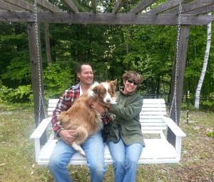 It's My Sustainable Life homestead life with husband and wife holding dog on swing in garden