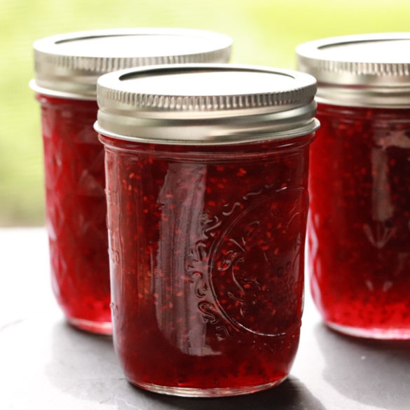 red raspberry jam in mason jars image showing 3 jars of jam