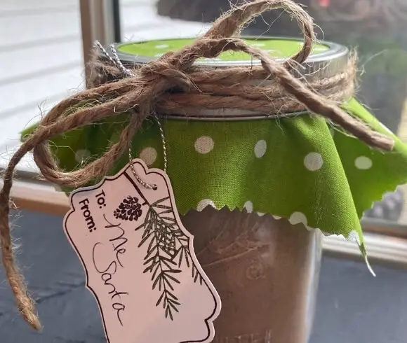 Easy Homemade Hot Chocolate Mix shown in mason jar with festive green and white polka dot material on top tied with twine and a gift tag