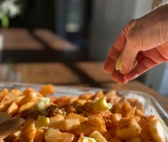 Homemade Gluten-Free Apple Crisp image showing sliced apples that have been flavored with sugar & spices being topped off with a few pads of butter