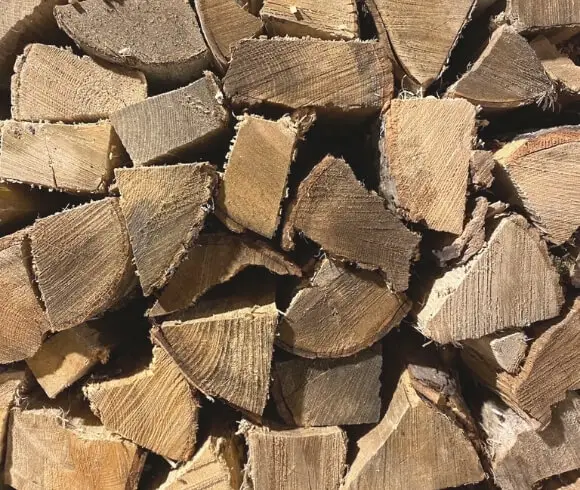 Heating With Wood image of ends of wood stacked upon one another