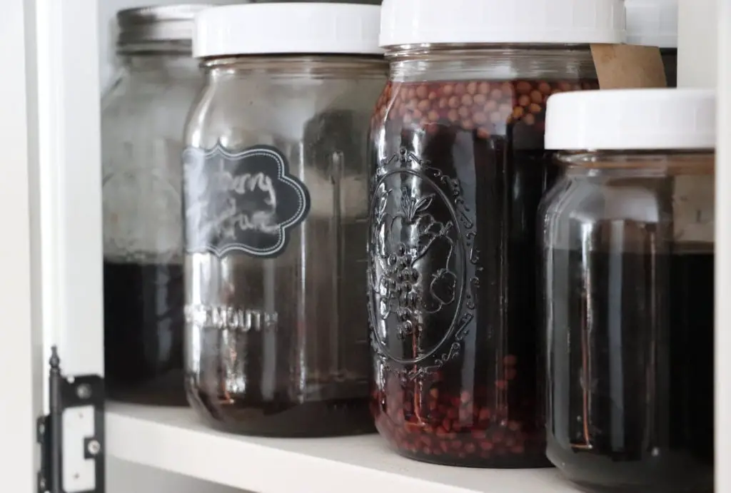 Home Apothecary Essentials image showing closeup of mason jars with home remedies in them