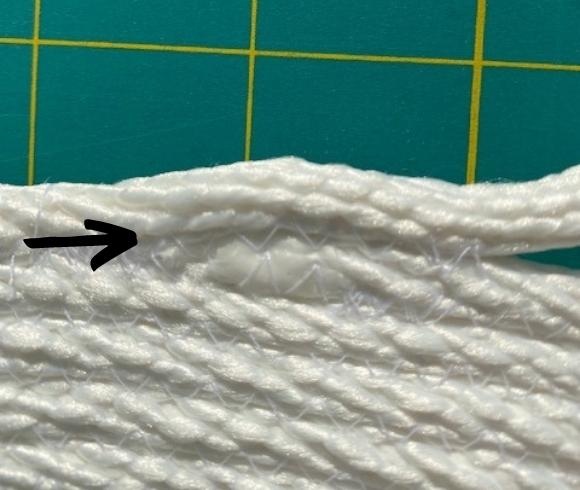 Rope Bowl Tutorial image with a small black arrow pointing to the top row of the handle, or where it should be stitched